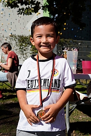 Ein junger Teilnehmer beim Baumlauf des ÖDP-Kreisverbands Ein kleiner Junge mit einer Medaille strahlt in die Kamera